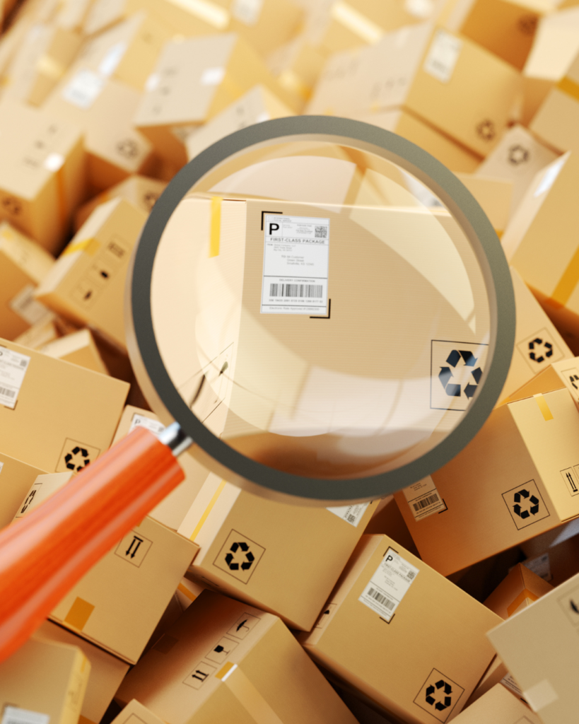 Heap of cardboard boxes and magnifying glass zoom in parcel label